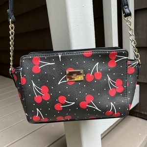 Black leather-like purse with red cherries and gold accents